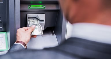 Businessman Withdrawing Cash From an ATM