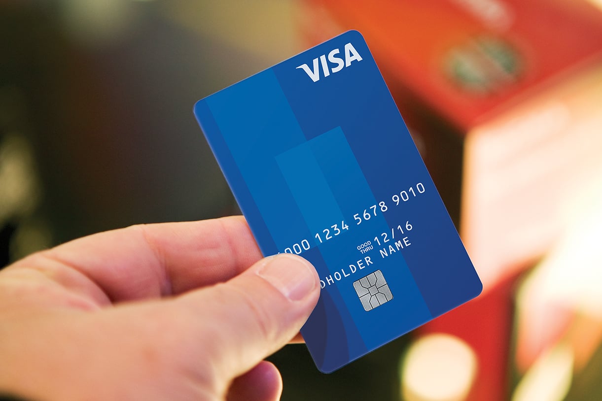 Person holding a Visa card