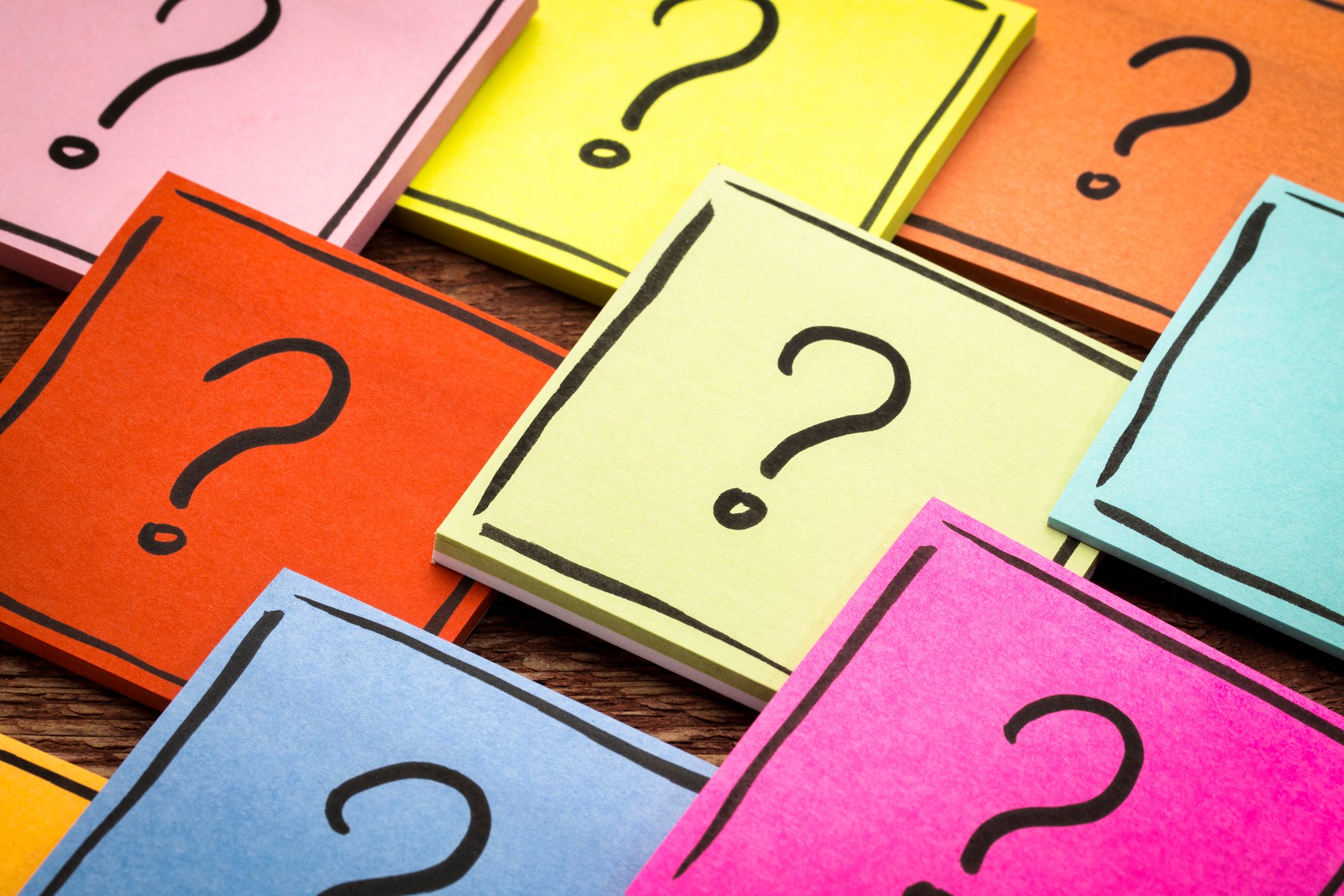 Colorful Post-It Notes with a question mark drawn on them.