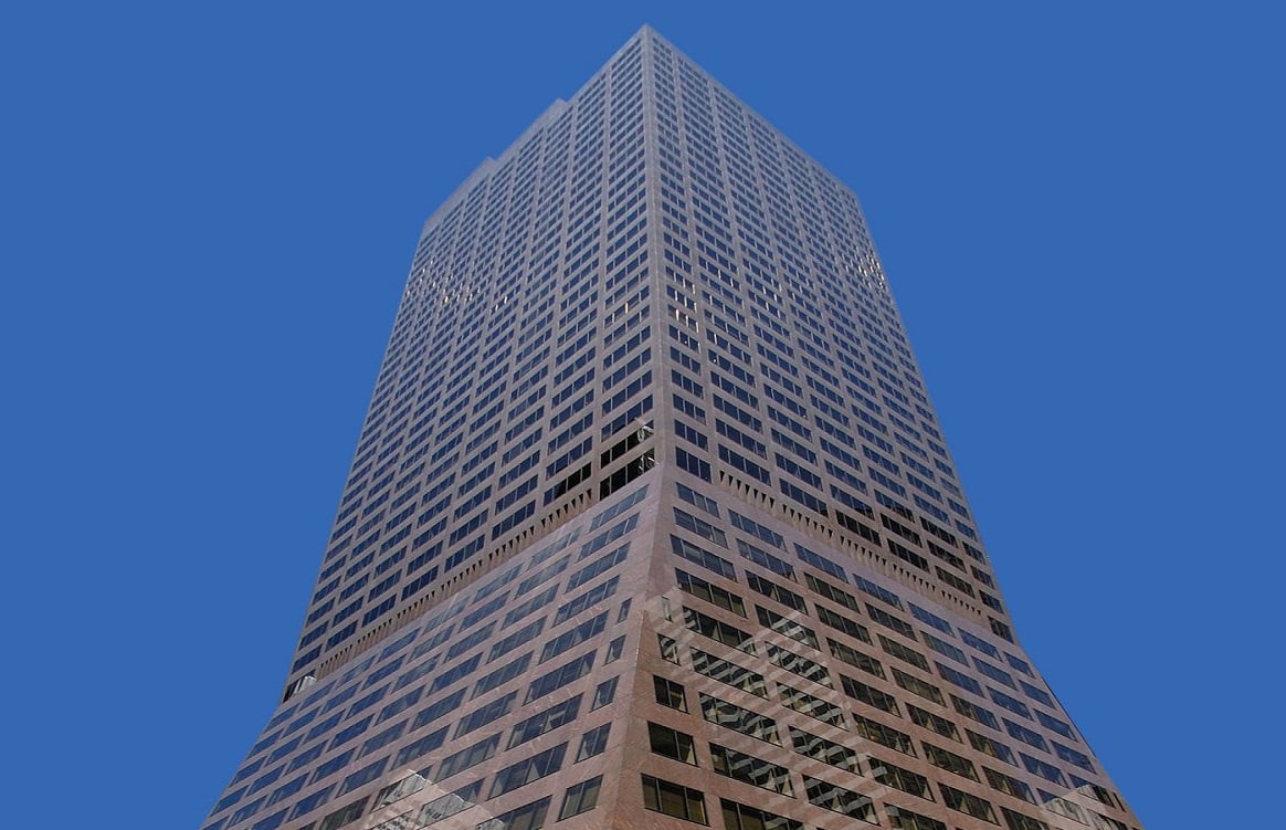 Brown-colored office building against a blue sky.