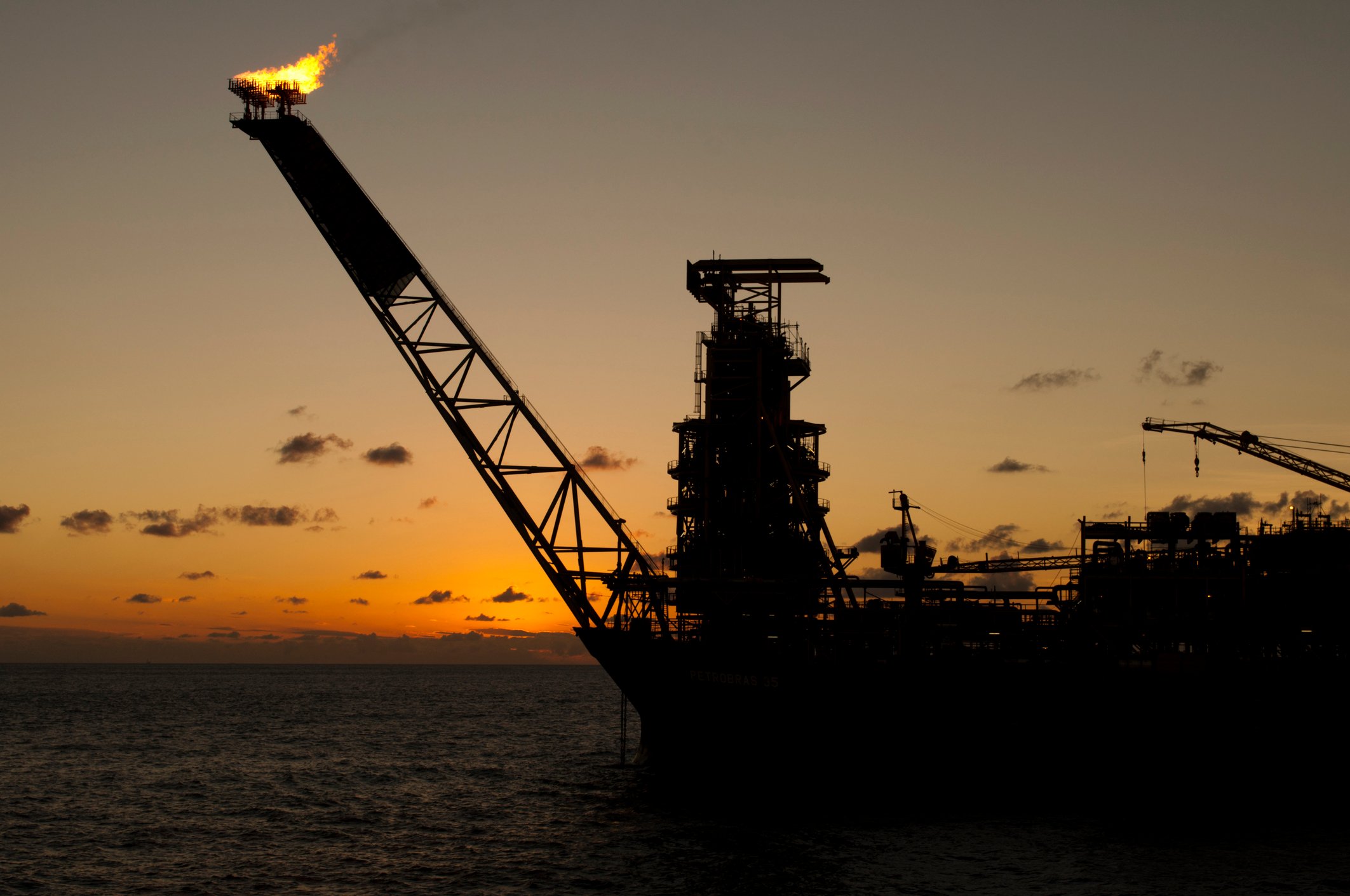 Floating production, storage, and offloading facility at sunset.