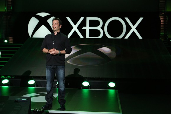 A man standing on stage at an Xbox media briefing.