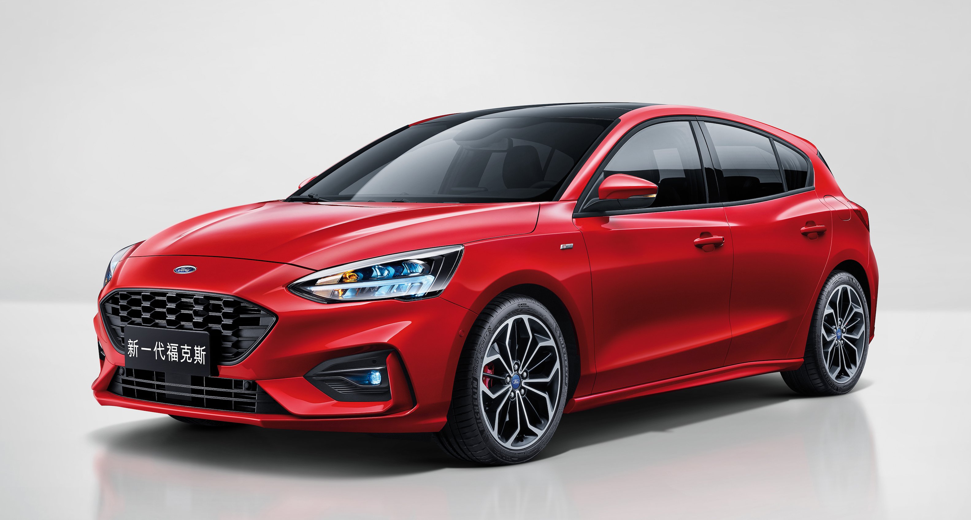  A red 2019 Ford Focus, a four-door hatchback, with Chinese license plates.