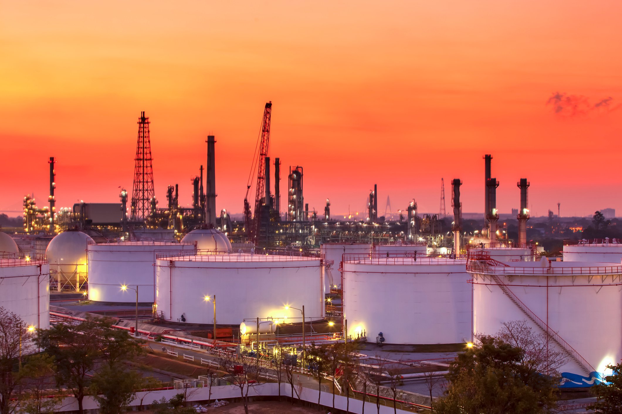 Refinery & oil storage tanks at sunset