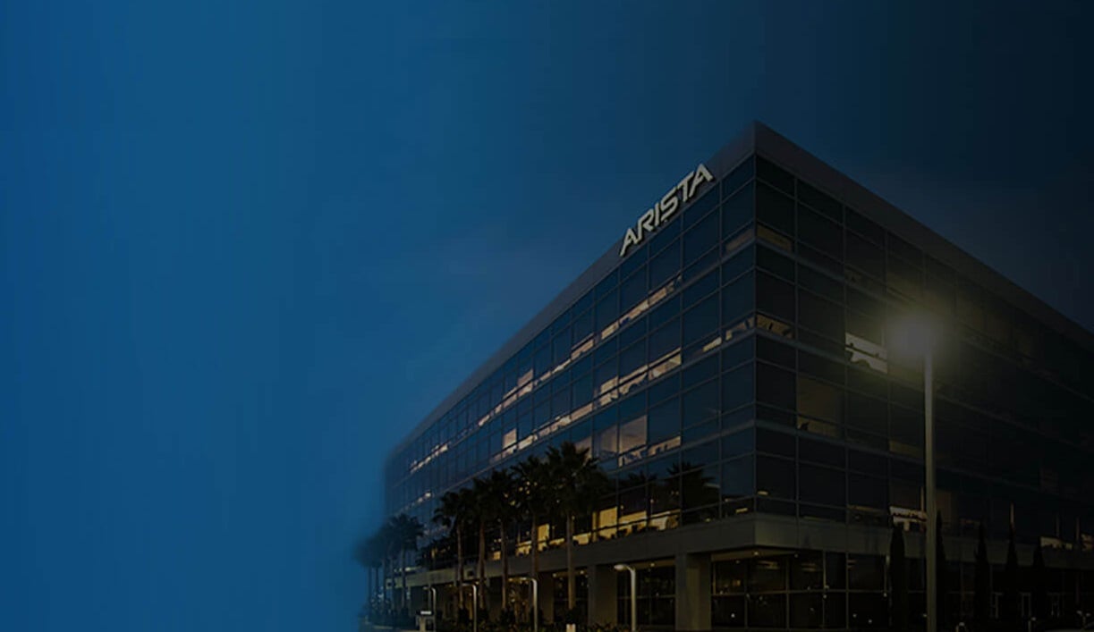 Building at twilight with Arista logo on side.