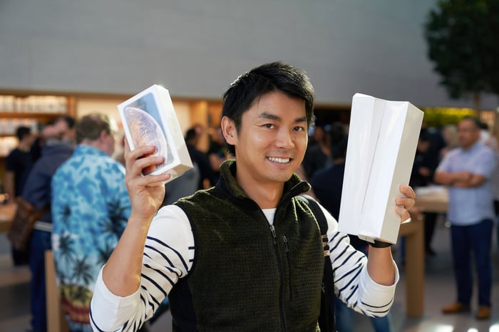 A man holding Apple products in an Apple store