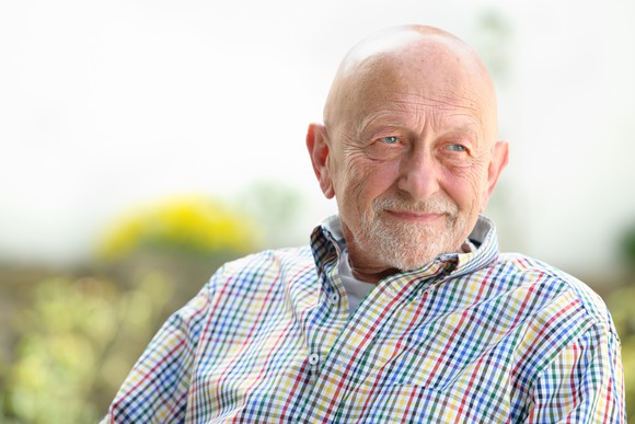 Smiling older man outdoors.