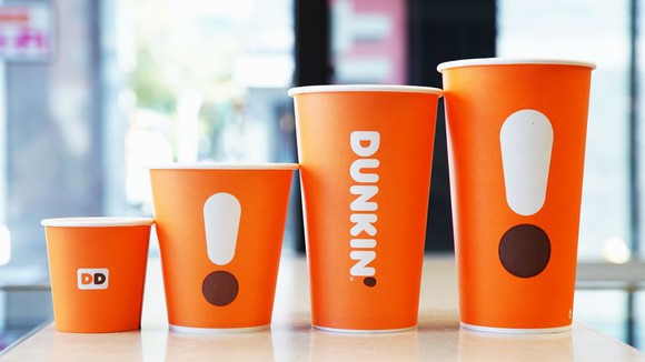 Lineup of new orange, minimalistic Dunkin' coffee cups.