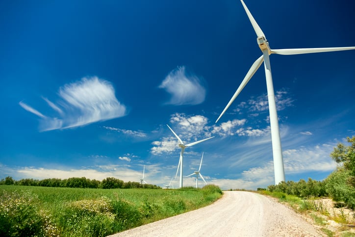 Wind turbines along a country road.