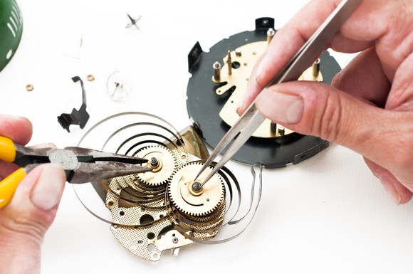 Watchmaker working on a complicated clockwork system.