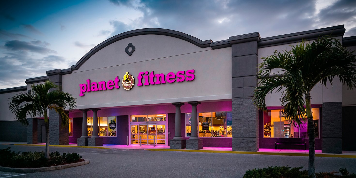 Planet Fitness gym exterior with palm trees