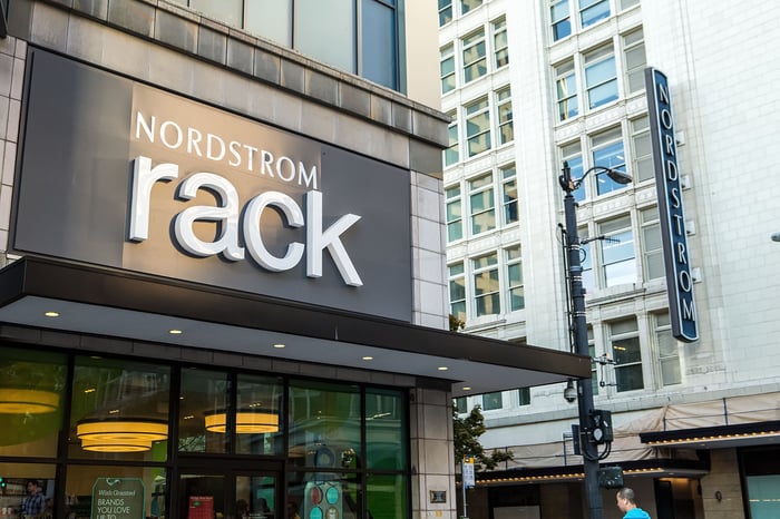 The exterior of a Nordstrom Rack store, with the Nordstrom Seattle flagship store in the background