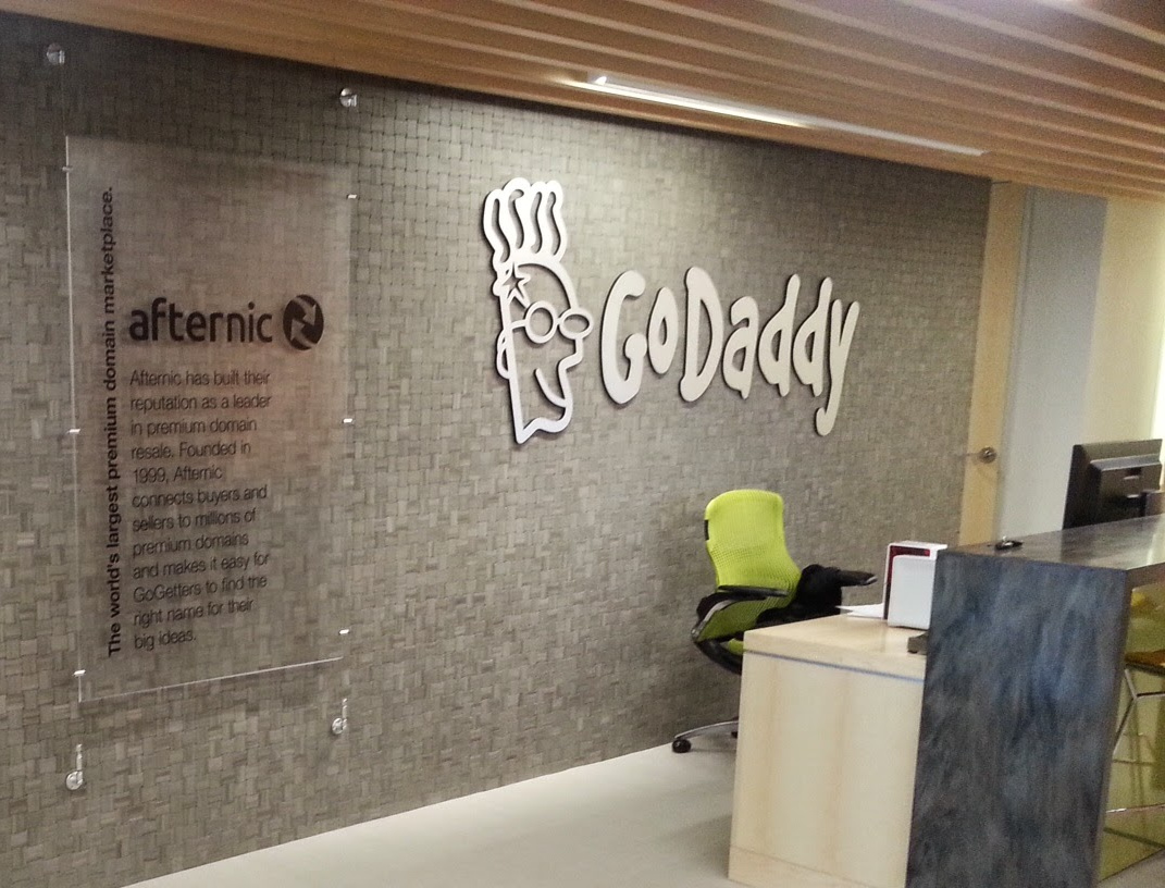 A GoDaddy logo on the wall of the company's office lobby in Cambridge, Massachusetts.