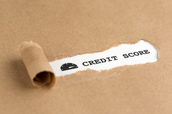 Paper being torn to reveal text that says Credit Score.