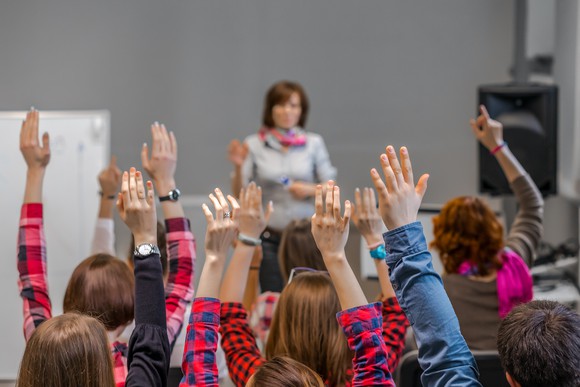 Active Students raising Arms up ready to answer Teachers Question