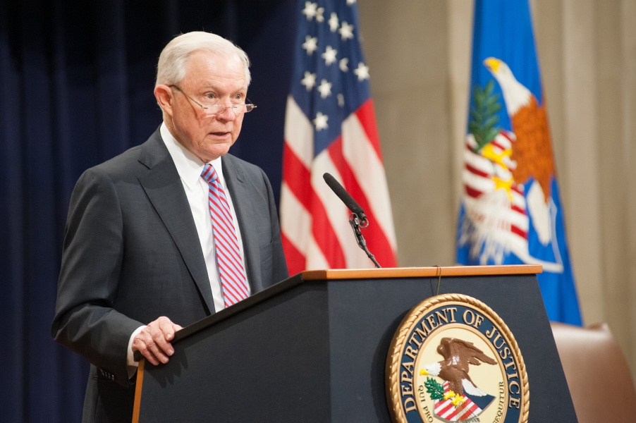 Former Attorney General Jeff Sessions speaking to an audience from behind a podium.