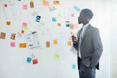 man looking at wall full of info getty