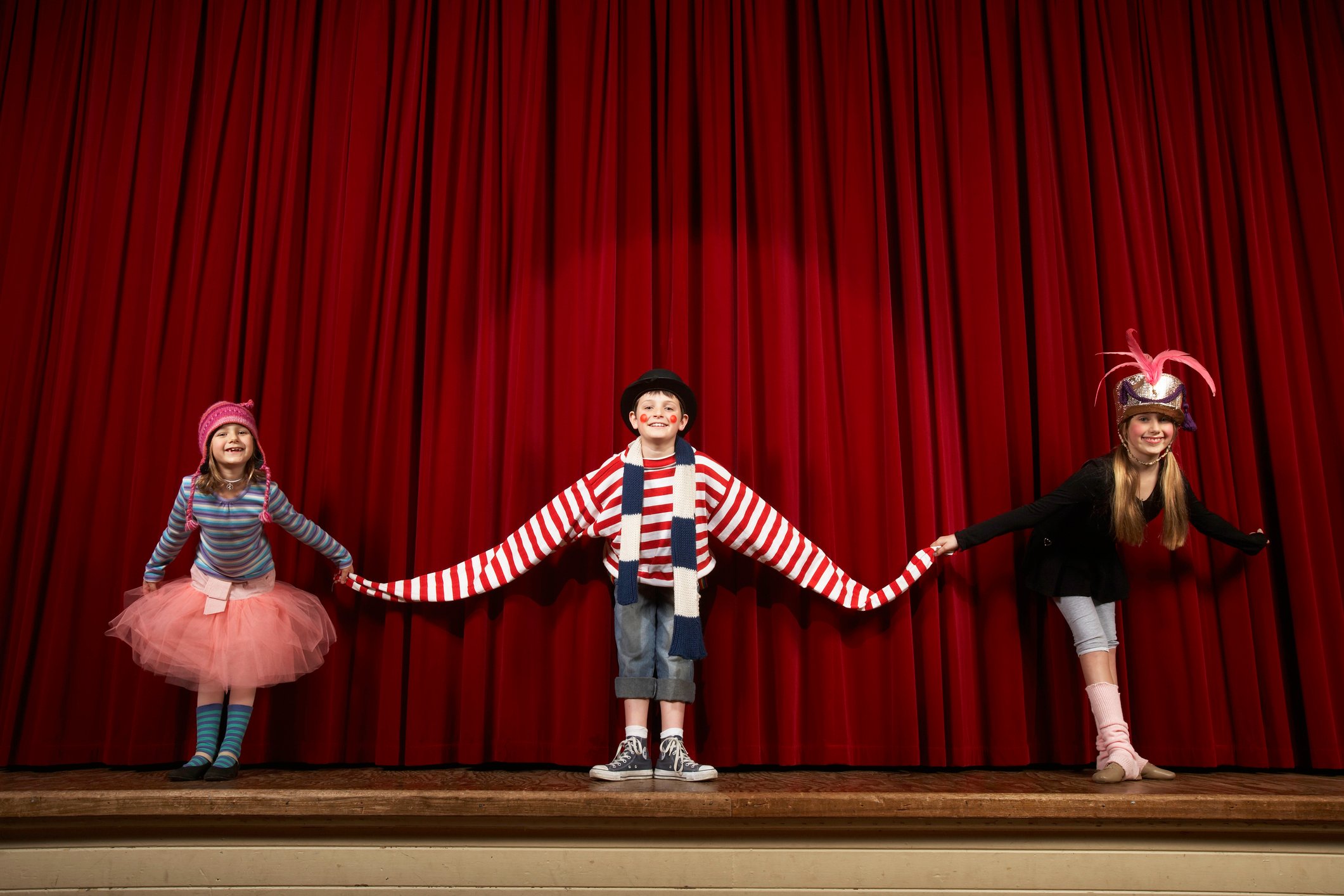 Children in clown costumes making curtain call.