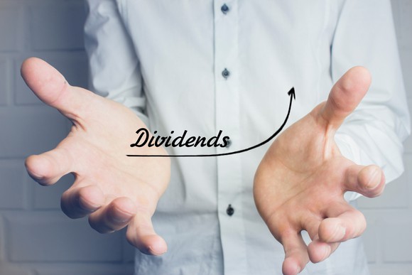 A businessman "holds" a chart of rising dividends.