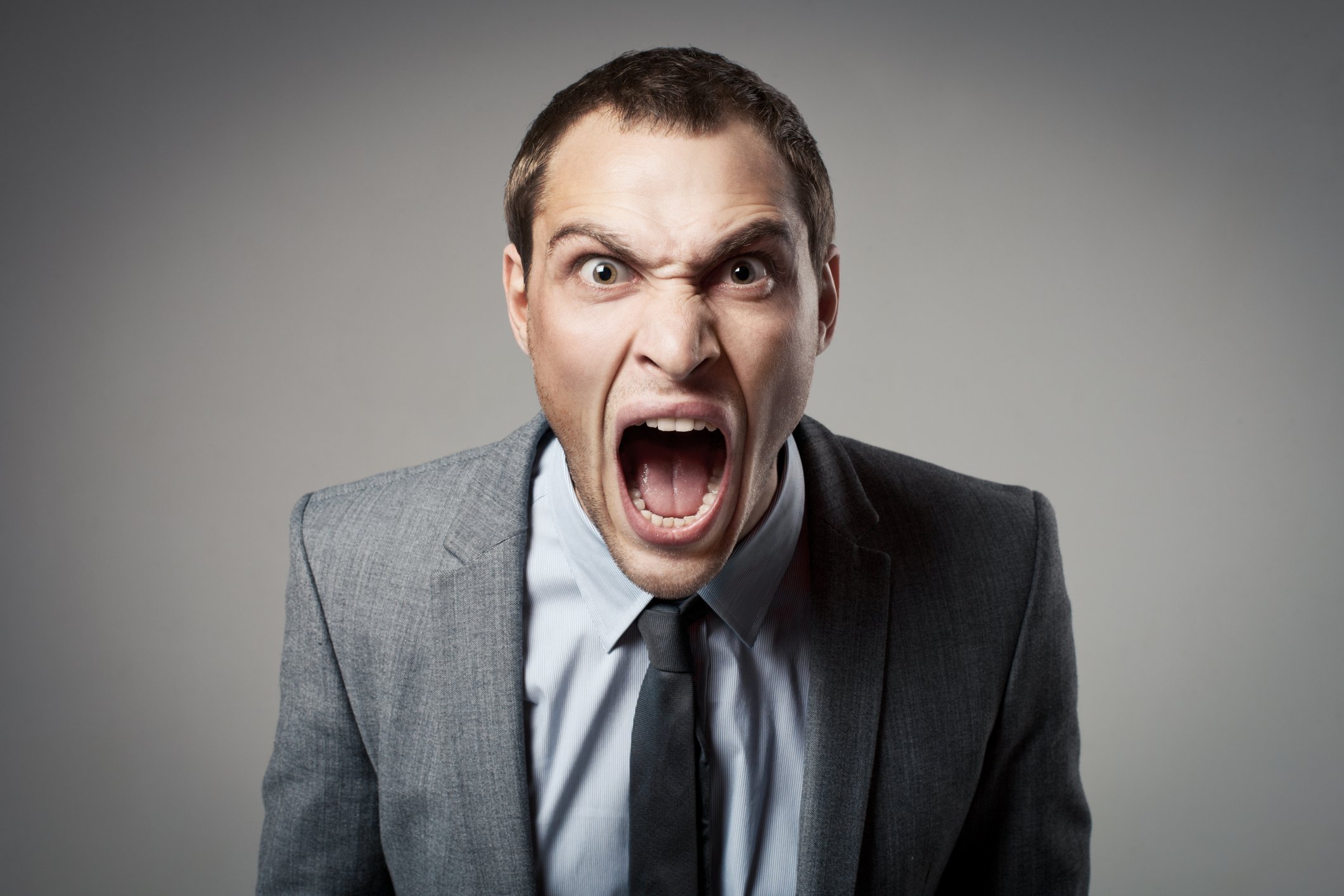 Man in suit yelling.