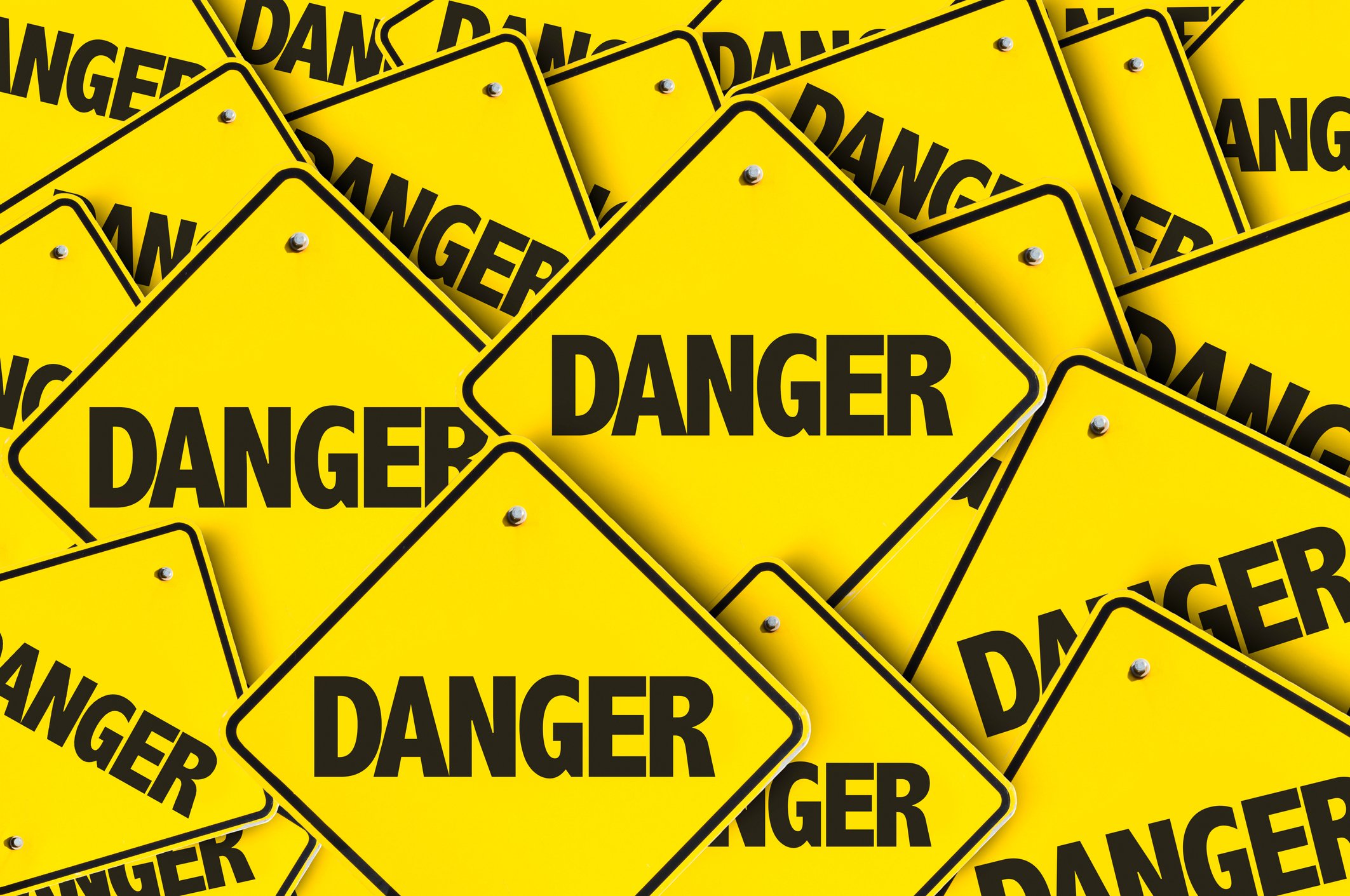 A pile of yellow danger signs