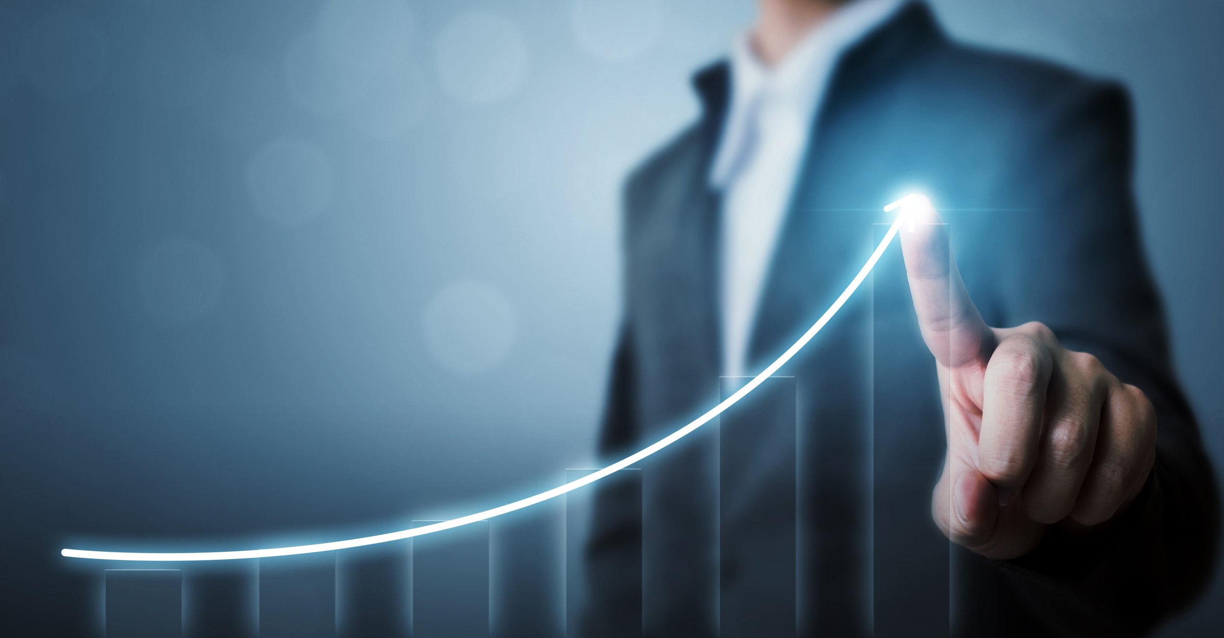 A person pointing to an upward-sloping chart