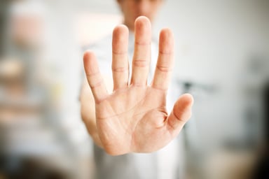 Man with hand up to stop