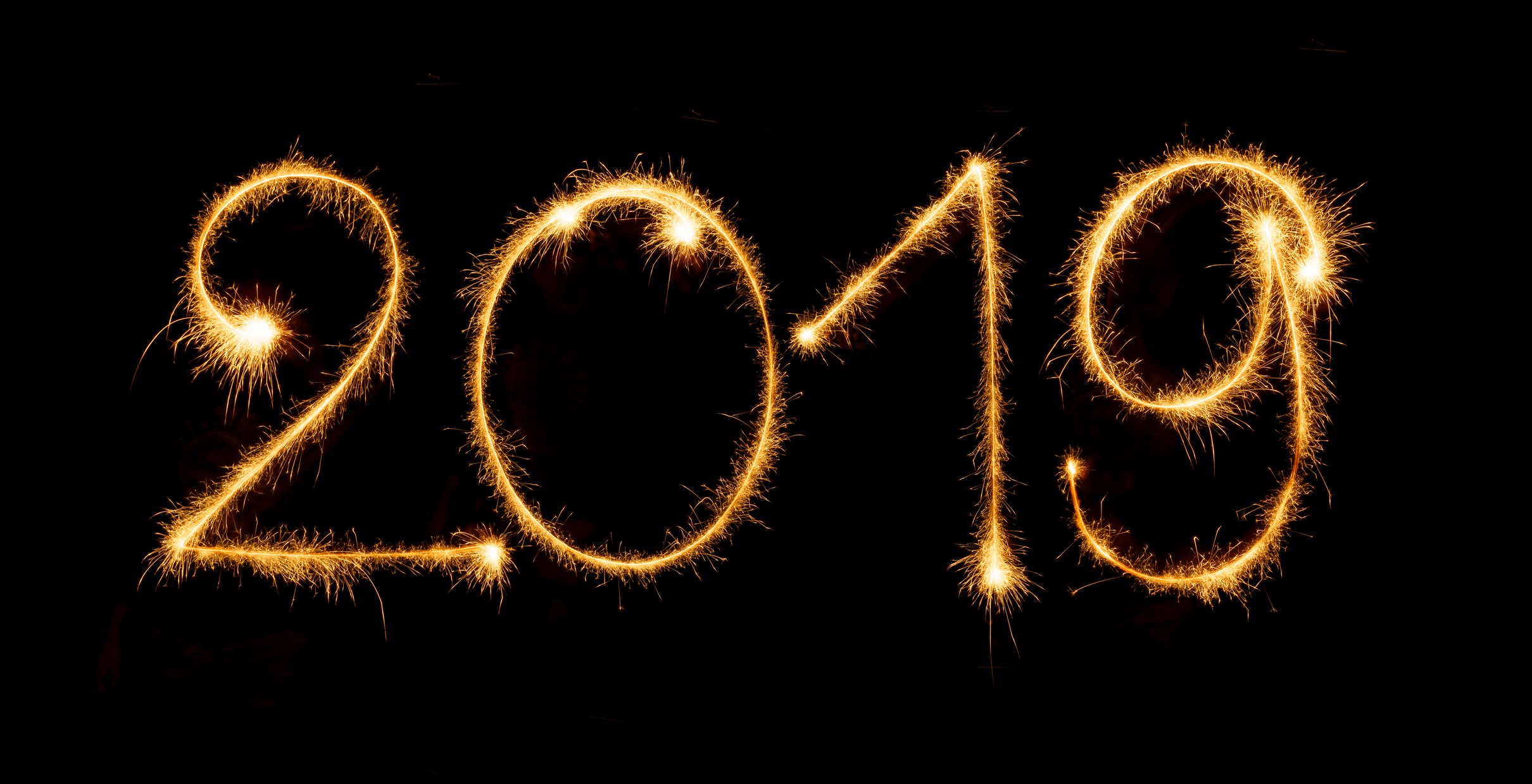 Numbers 2019 in European format set out in sparkler on a black background.