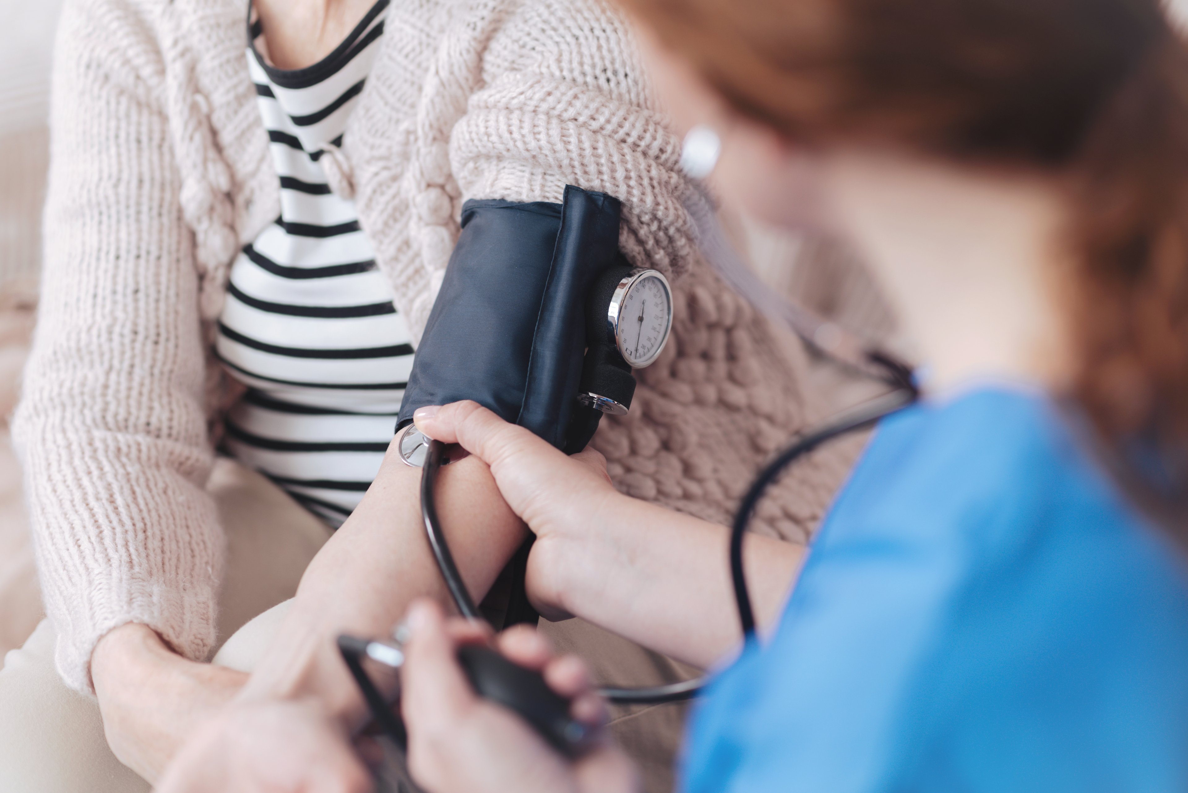A doctor takes a patient's blood pressure
