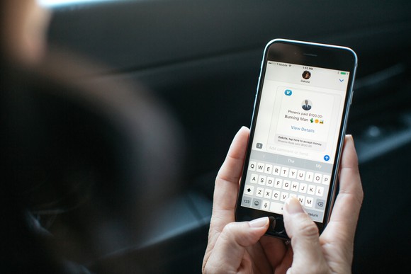 A woman sending money using the Venmo app.