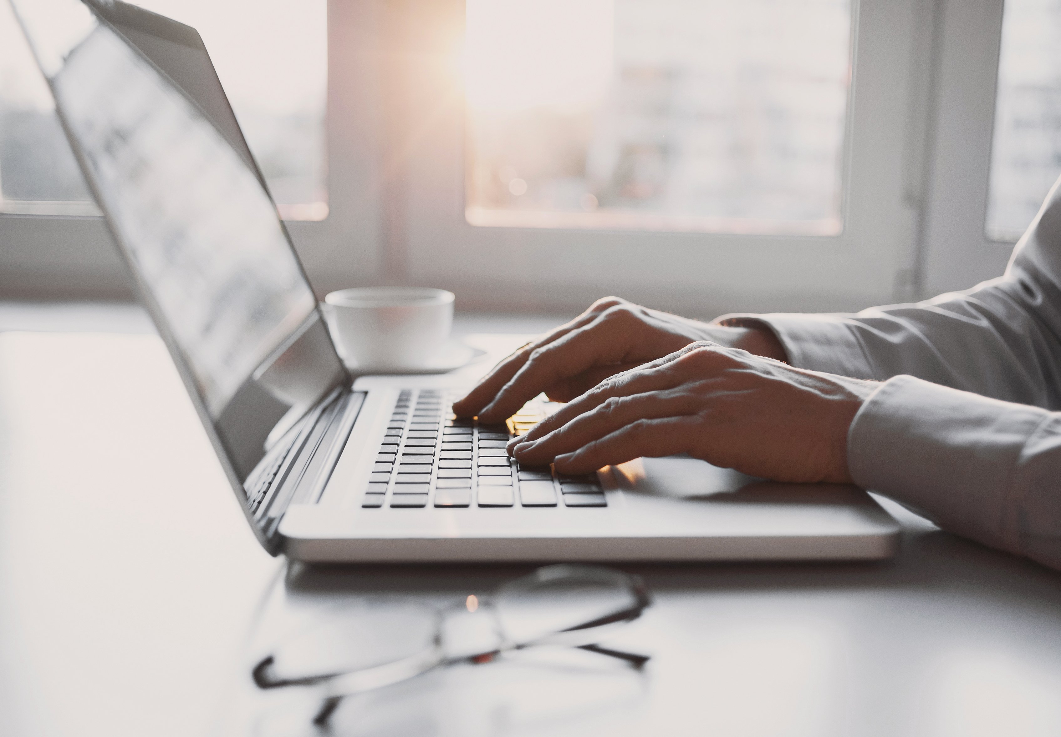 Man typing on a laptop.
