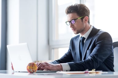 man in suit at laptop_GettyImages-694927914