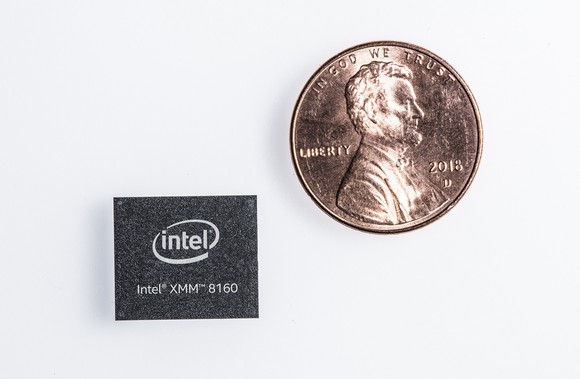 An Intel XMM 8160 chip next to a penny in a size comparison, with the chip being smaller.