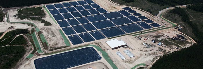 Aerial view of a fish hatchery with rectangular pools lined by Raven Industries' engineered films.