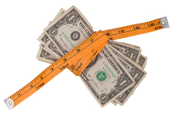 $1 bills secured in a bunch by a measuring tape.