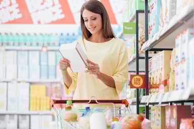 Woman Looking at Cereal Box in Dollar Store