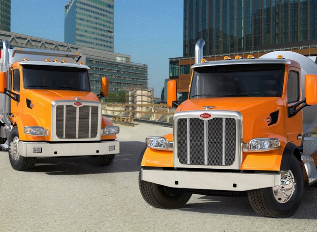 Two heavy-duty semi trucks parked.