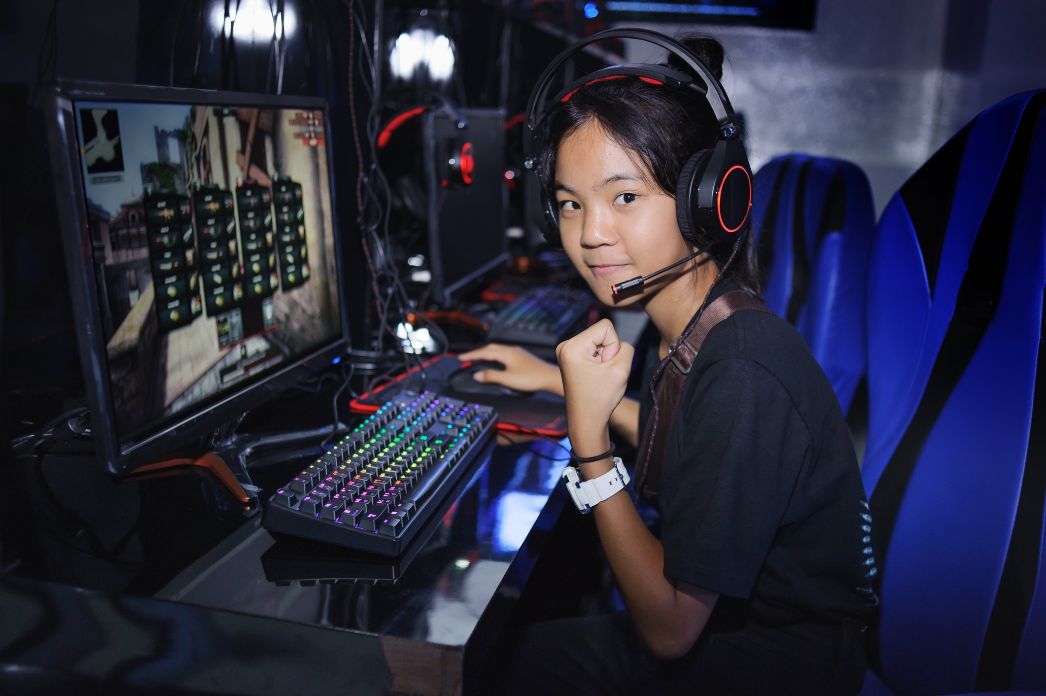 Girl gamer pumping fist playing PC game 