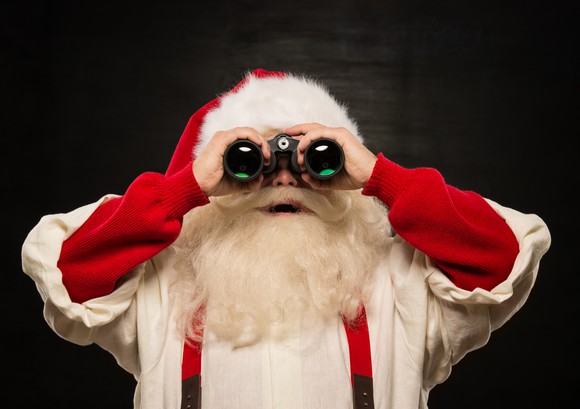 Santa Claus holding a pair of binoculars