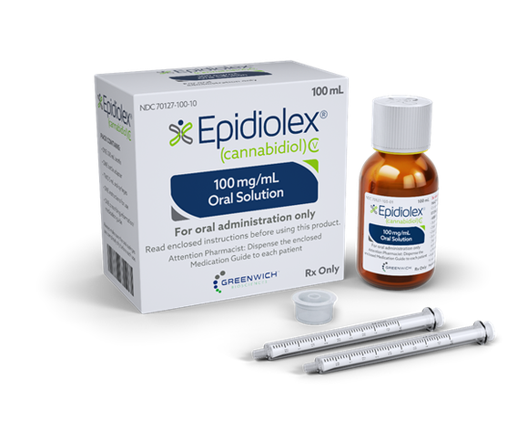A bottle of liquid Epidiolex, next to its packaging and two droppers