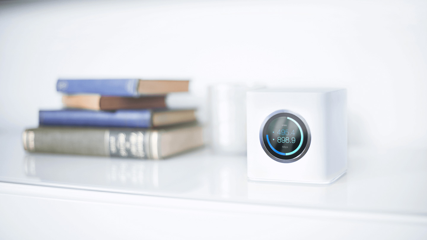 Contemporary-looking Ubiquiti Networks router on a white bookshelf