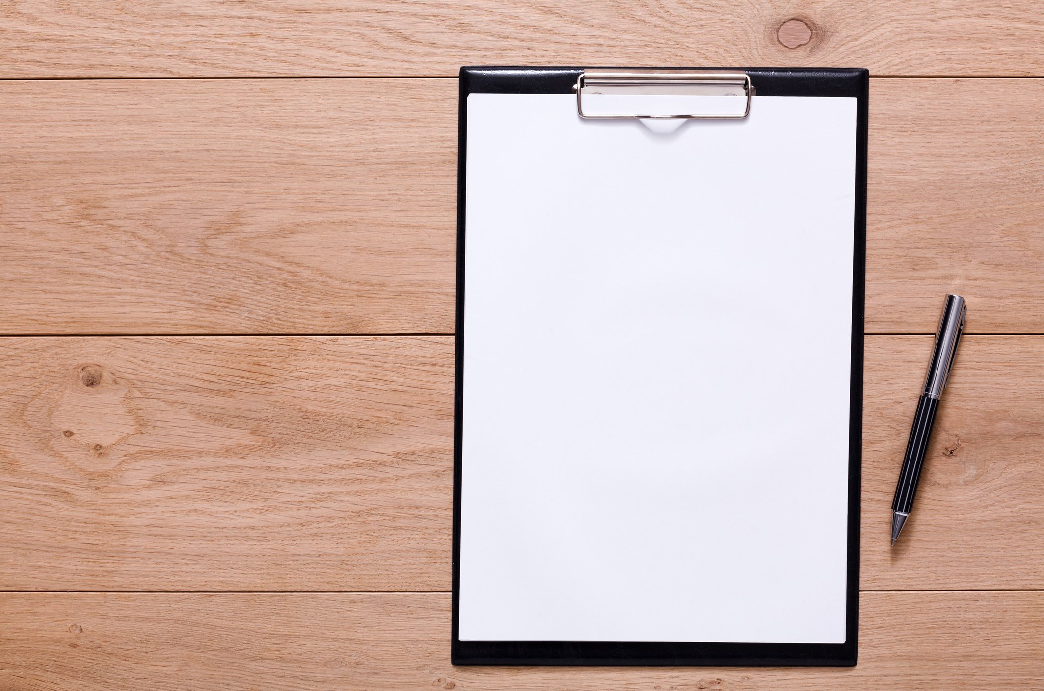 A blank piece of paper next to a pen.