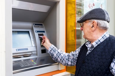 Older man using ATM