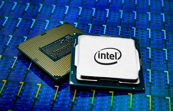 Two fully-packaged Intel desktop CPUs on a wafer of CPU dies.