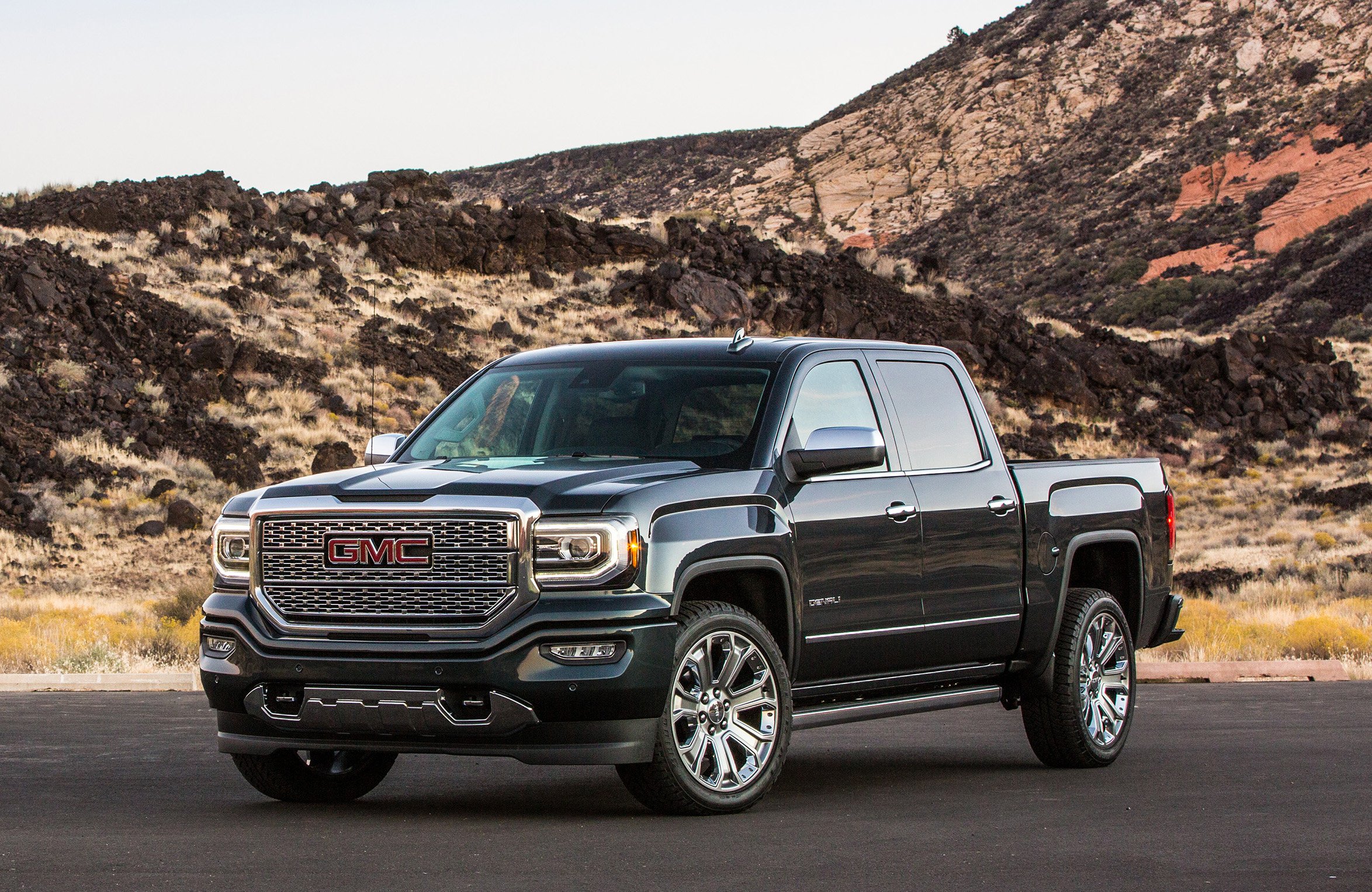 A 2019 GMC Sierra Denali, a full-size luxury pickup truck, parked on a mountain road.