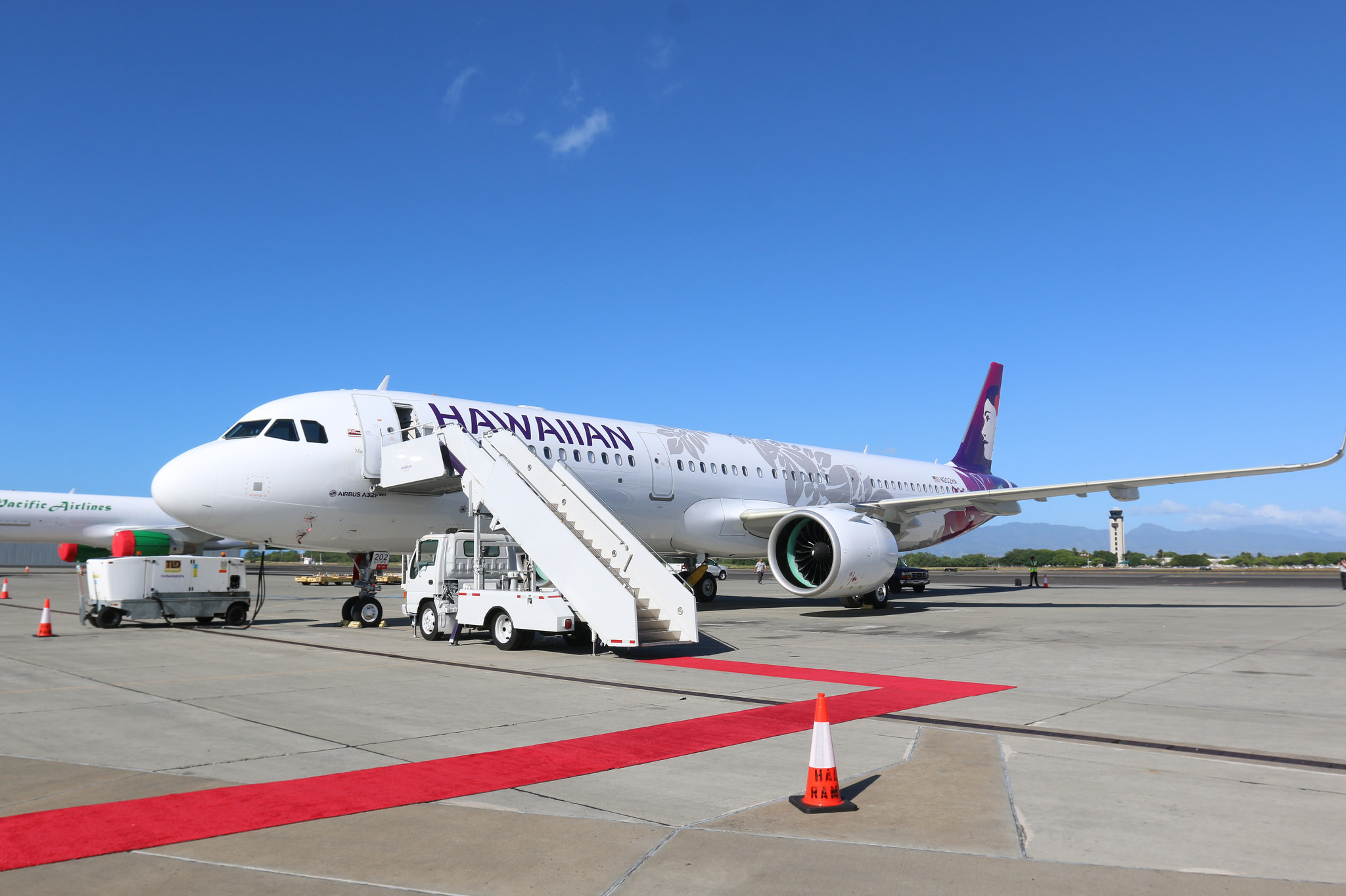 A Hawaiian Airlines A321neo parked on a tarmac.