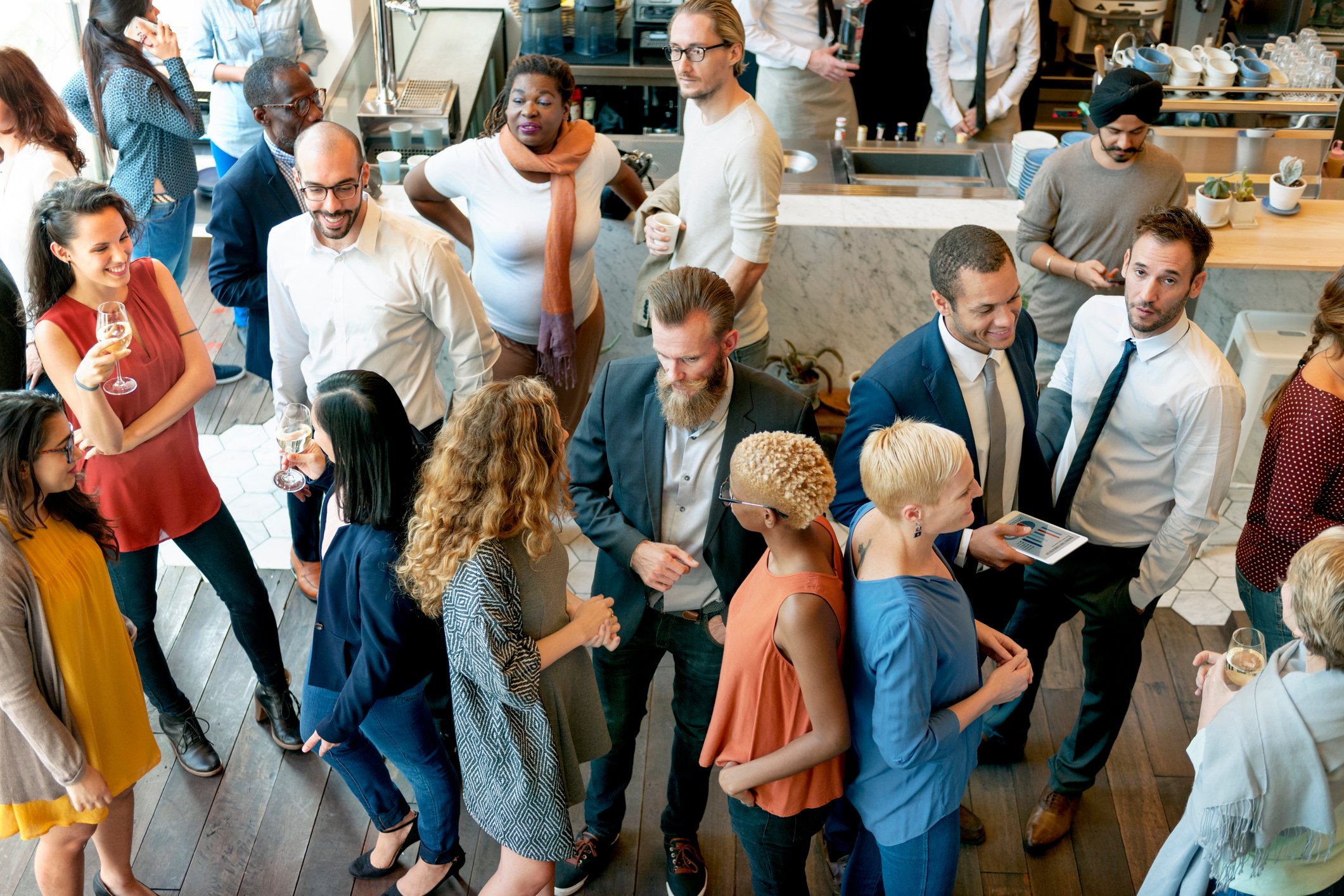 People mingle in a business casual setting.