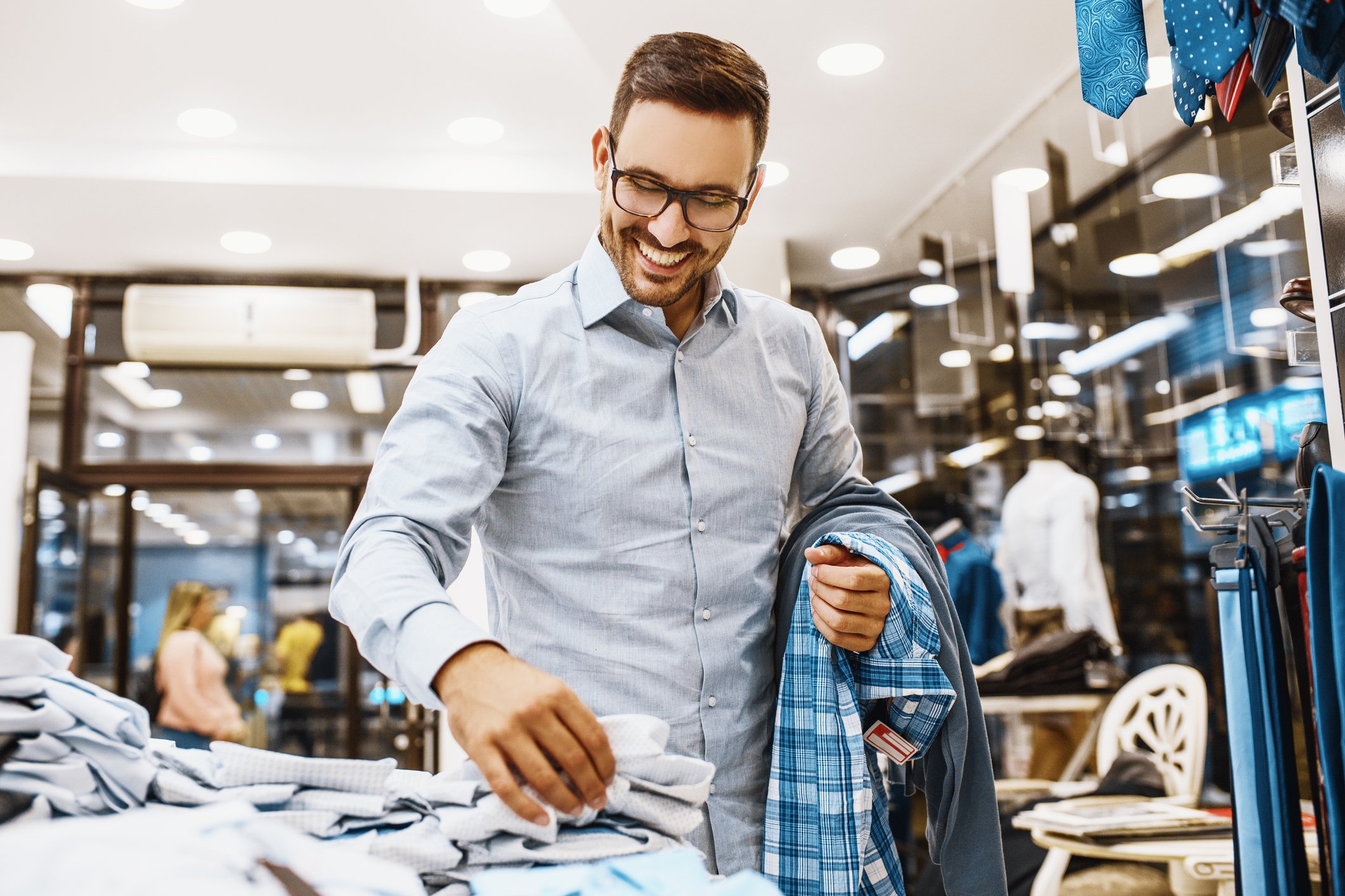A man shopping in a premium-apparel retail store