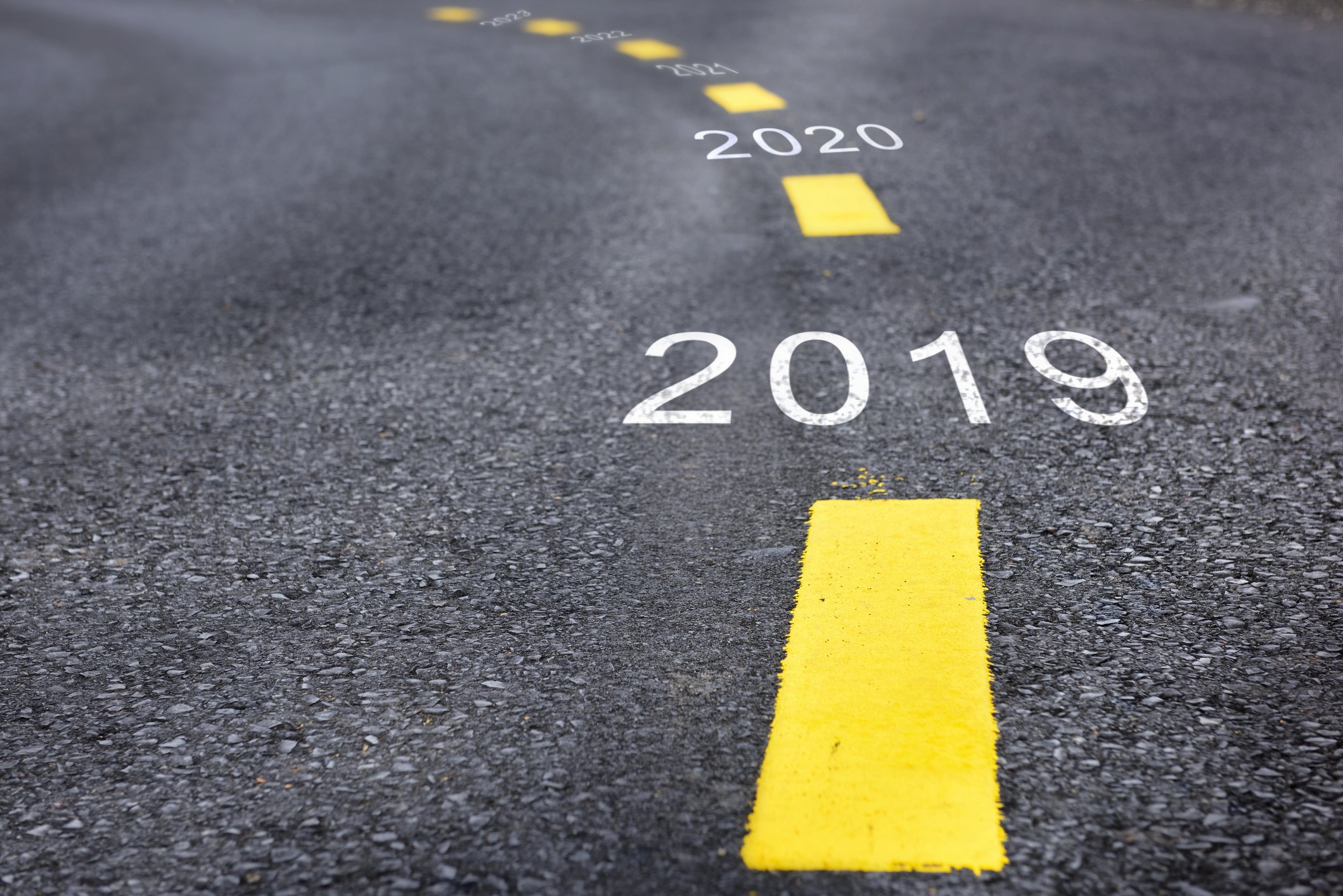 Road with 2019 and future years painted between dotted yellow lines.