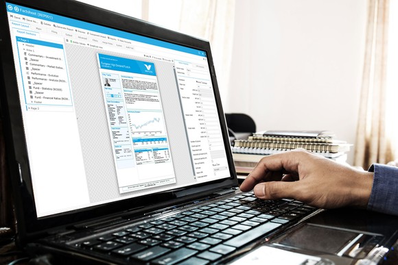 Hand on computer keyboard in front of monitor showing various information.
